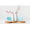 Two white vases with pink and white blossom branches on a table