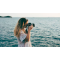 A woman photographing the ocean