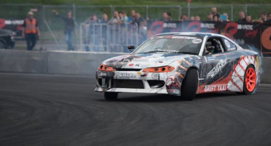 A race car drifting at fast speed along a race track