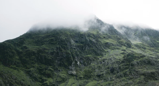 Lush green mountain landscape covered in clouds