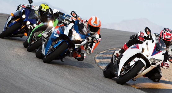 Motorcycle racers drive around a curve during a competition