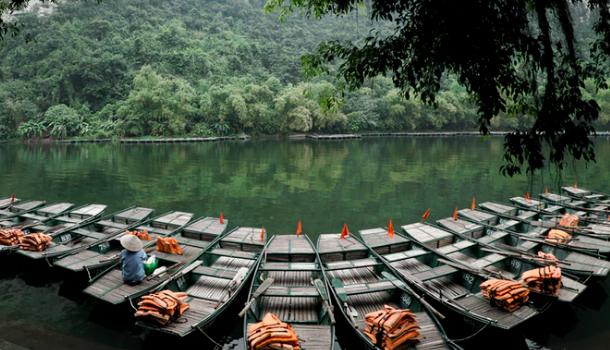 Lines of fishing boats docked on water in Ninh Bình Province