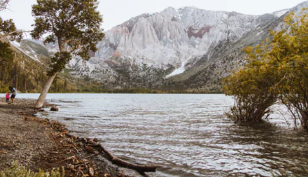 People at the edge of Convict Lake examining the stones